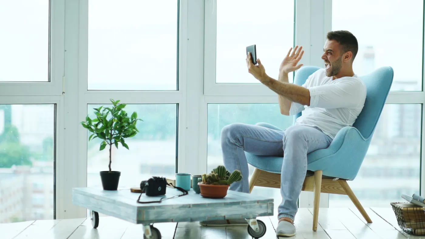 Person on a video call in a bright room with natural light and uncluttered space