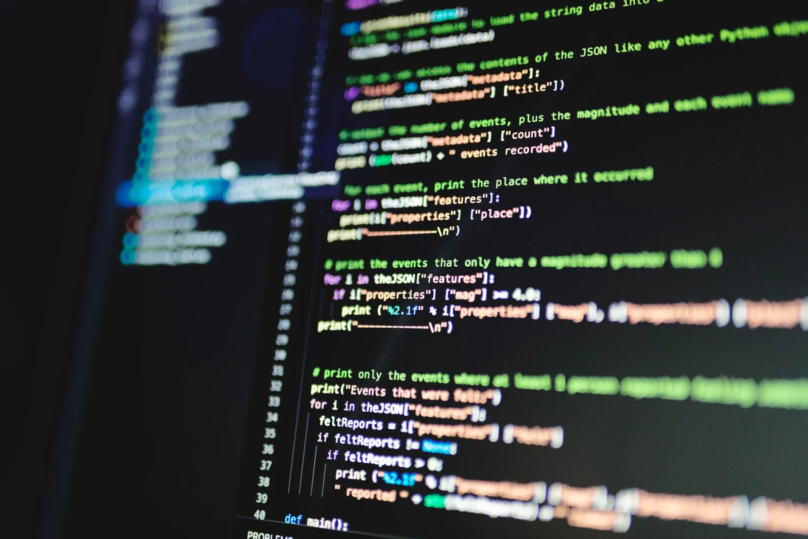 Colorful programming code on a dark monitor representing a CI/CD pipeline configuration