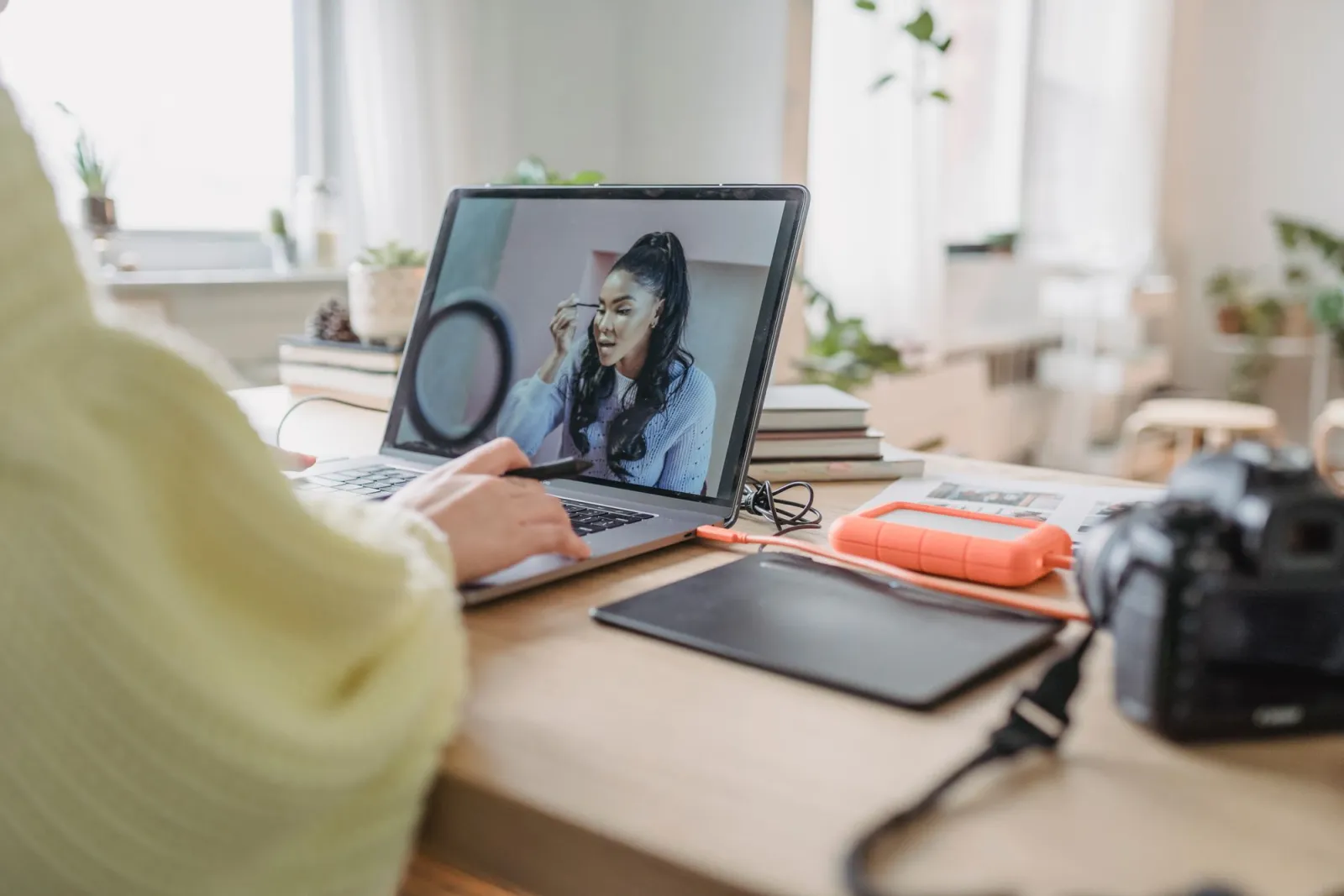 Photographer retouching a portrait on a laptop during post-processing