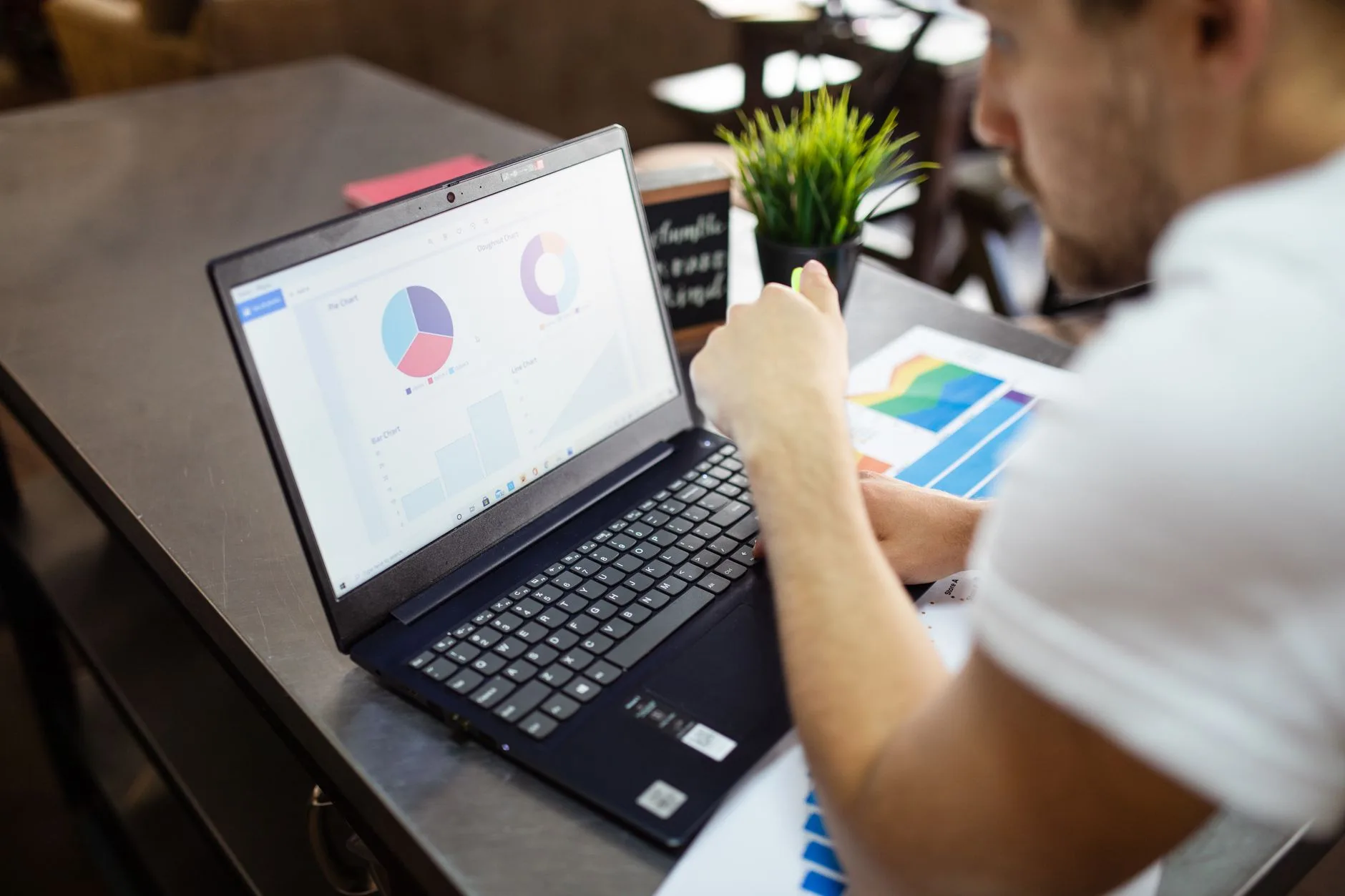 SEO analyst reviewing keyword and traffic charts on a laptop in a workspace