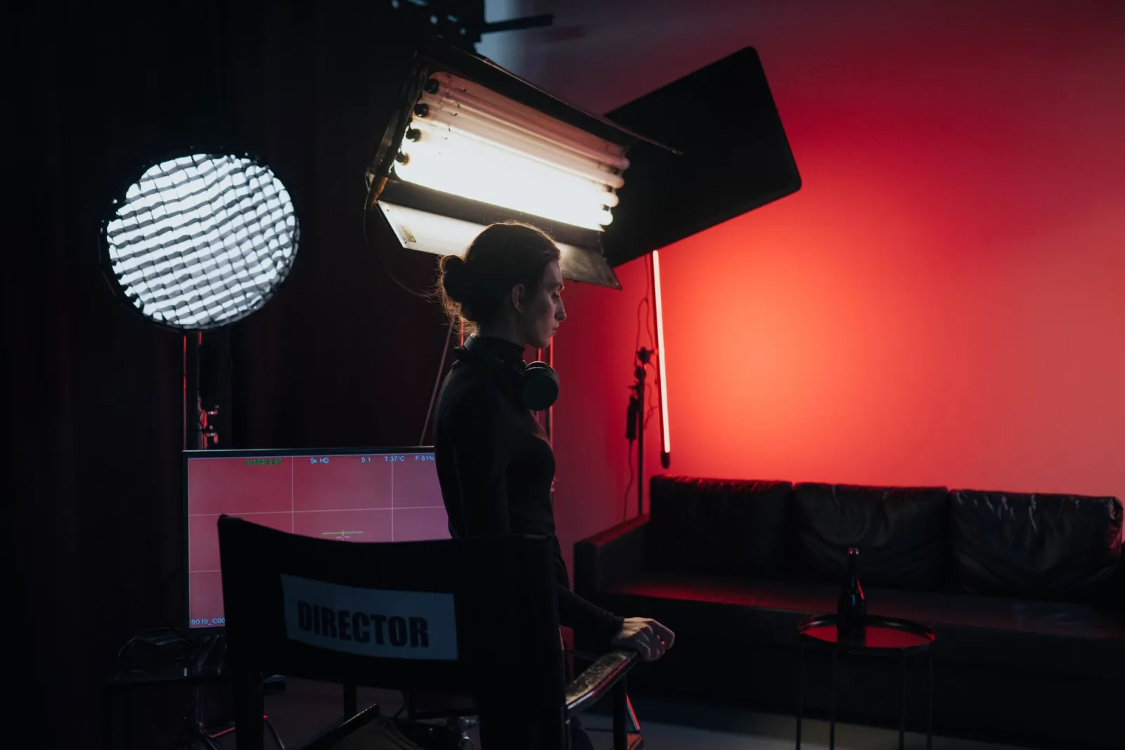 Director on a video production set with lighting and camera equipment in a studio