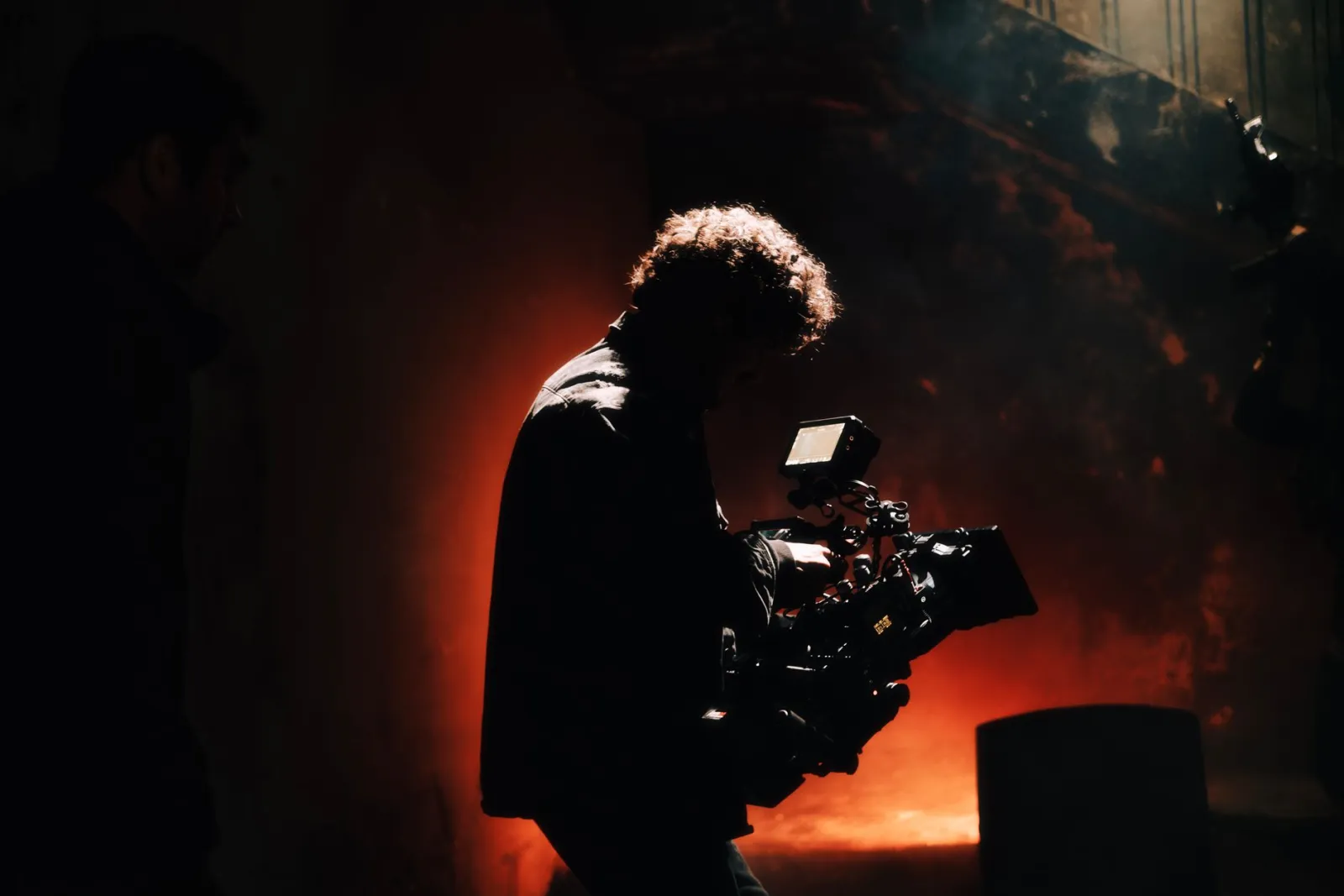 Camera operator filming a scene, the kind of footage that later needs cleanup and effects