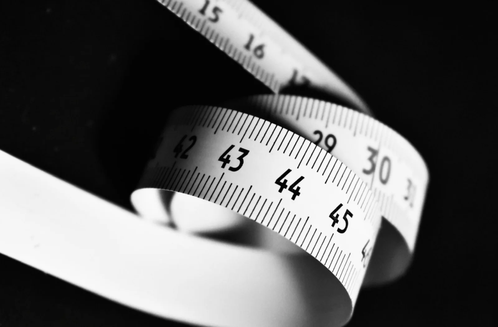 A curved measuring tape with numbers, showing how each measurement reads differently