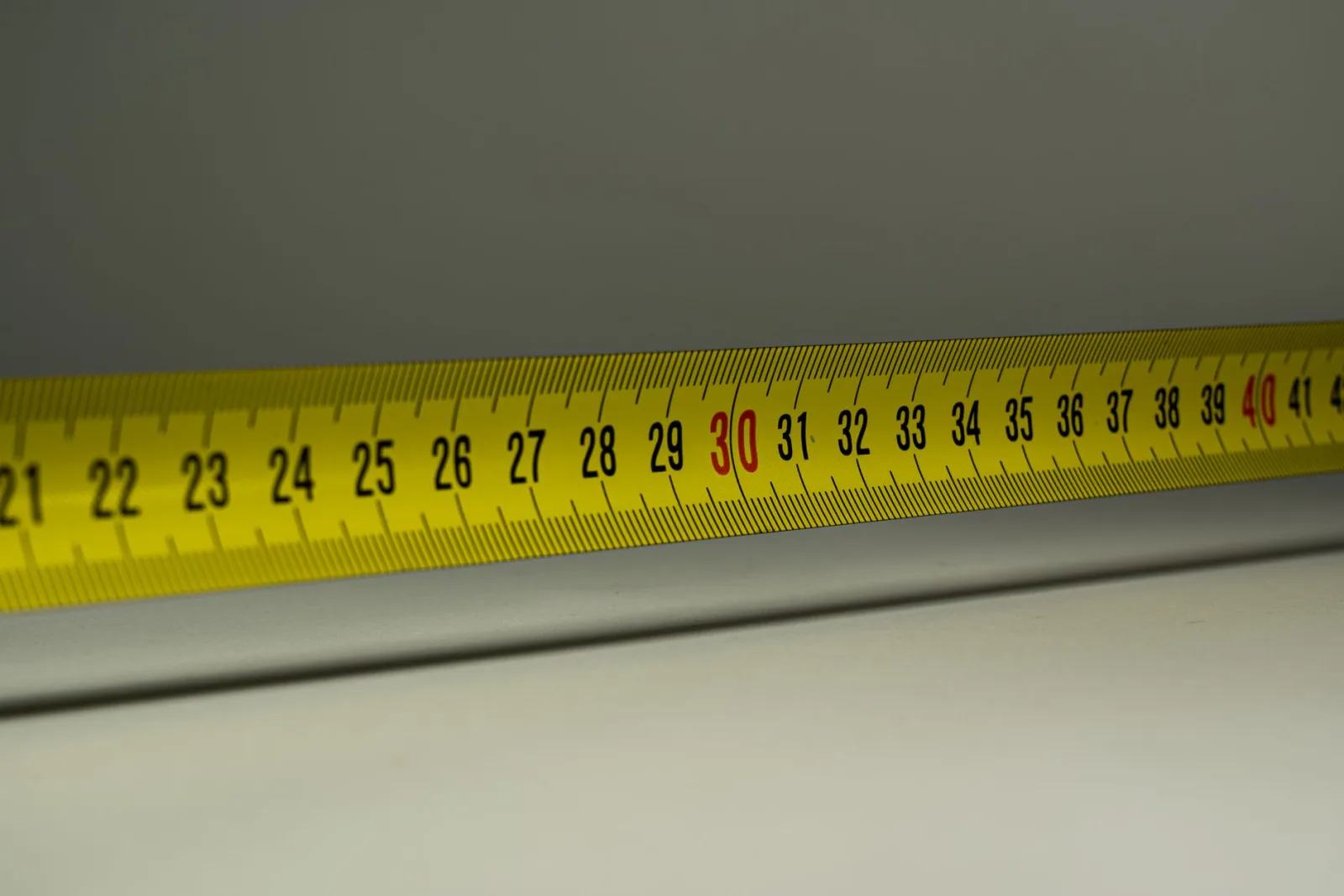 A close-up of a tape measure with numbers, analogous to reading an image's byte size