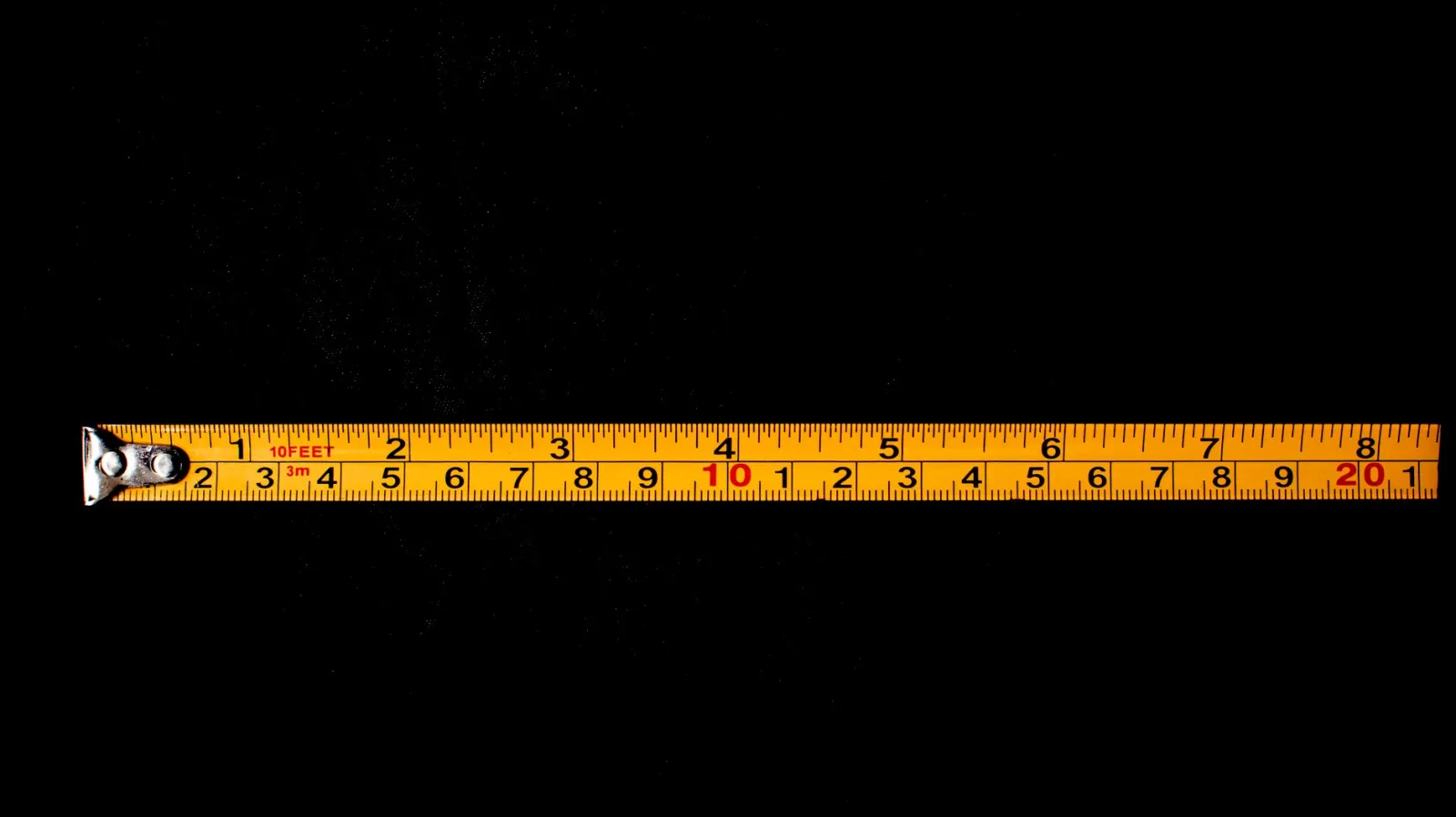 A yellow tape measure laid out flat, mirroring how dimension-checking measures pixel width and height
