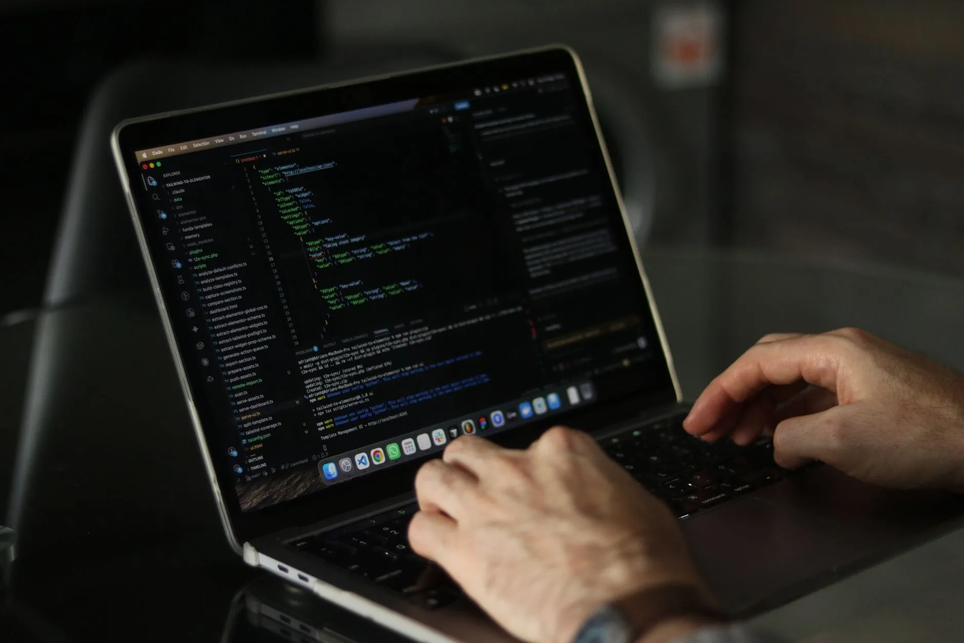 Developer hands typing code on a laptop while configuring an MCP server