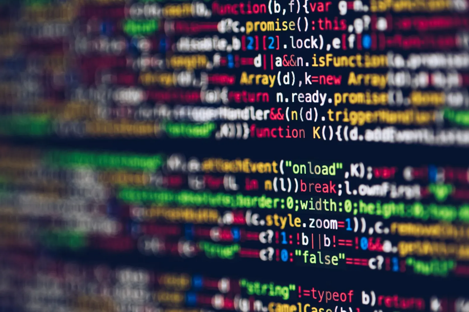 Blurred close-up of colorful programming code displayed on a screen