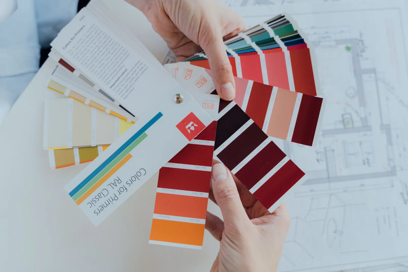 A designer choosing color palettes for an interior space, the same decision process used for digital design systems