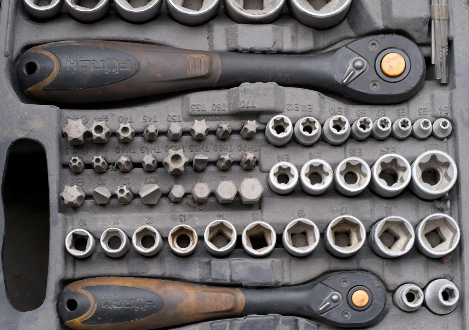 A detailed socket ratchet set with various attachments ideal for mechanical repairs.