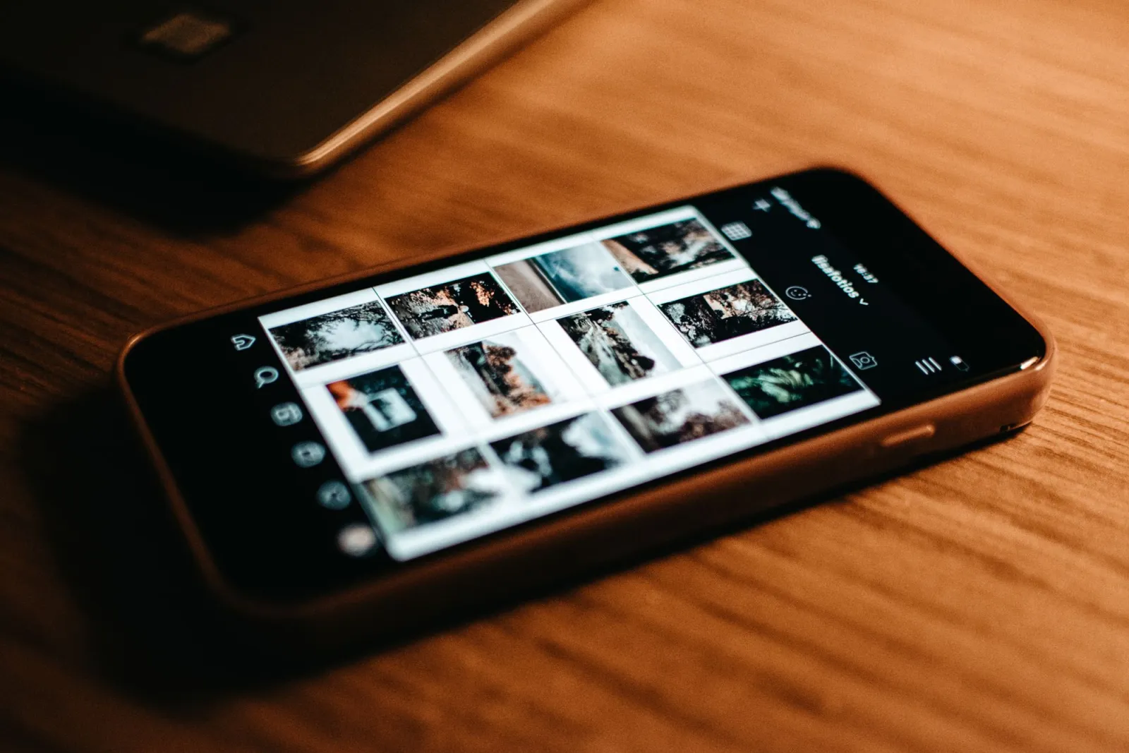 A smartphone photo gallery on a desk, the kind of image set you would batch crop to one ratio
