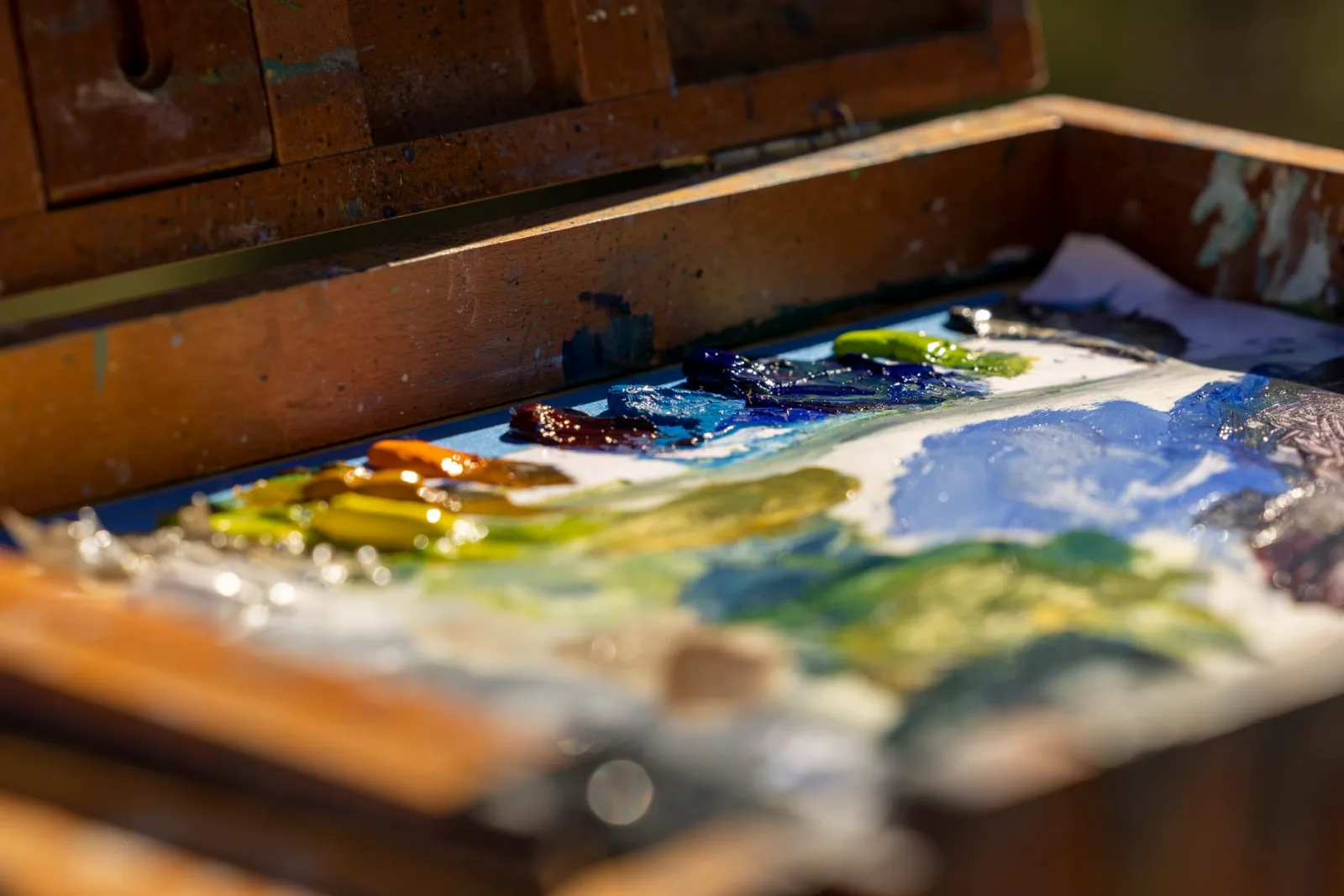 An artist's paint palette with various colors, showing how multiply darkens by combining values