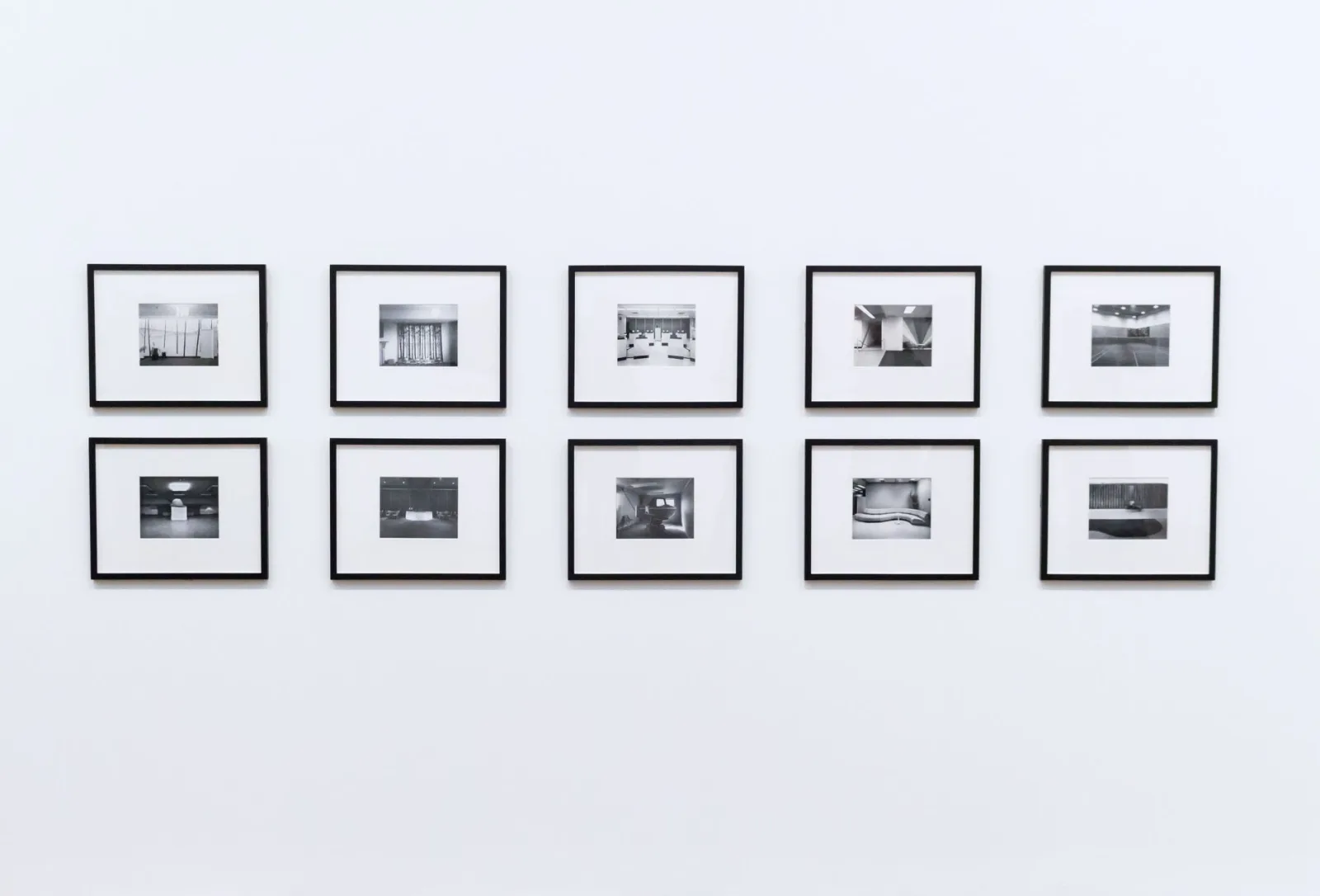 An elegant wall display of framed photos showing how borders work in a gallery context