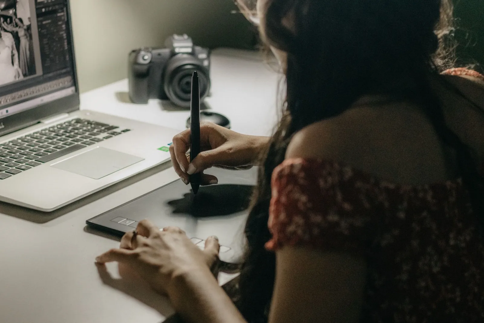 A woman using a drawing tablet while working, the precision tool for selective color correction