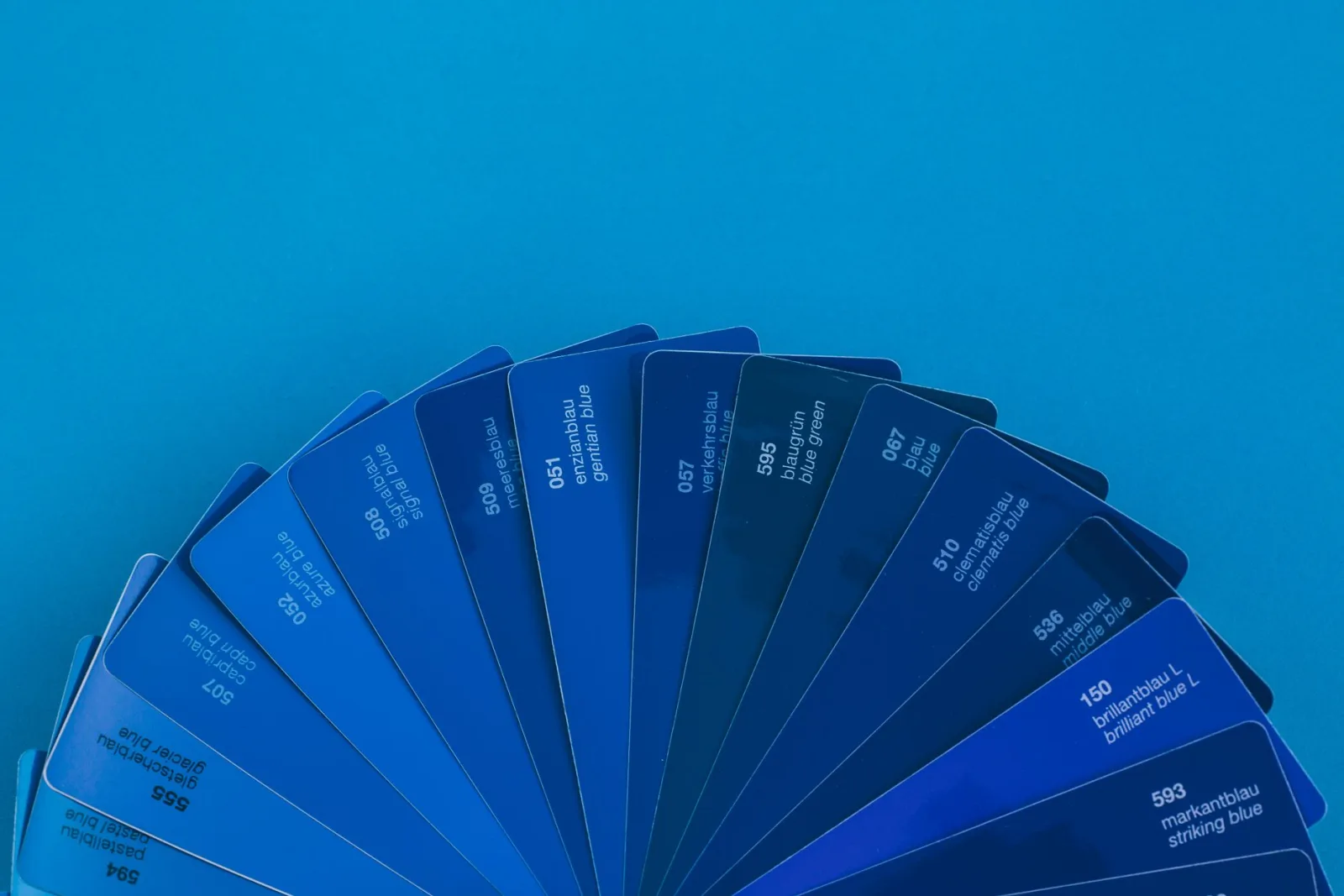 A fan of blue color samples, showing how grayscale strips hue to leave tone