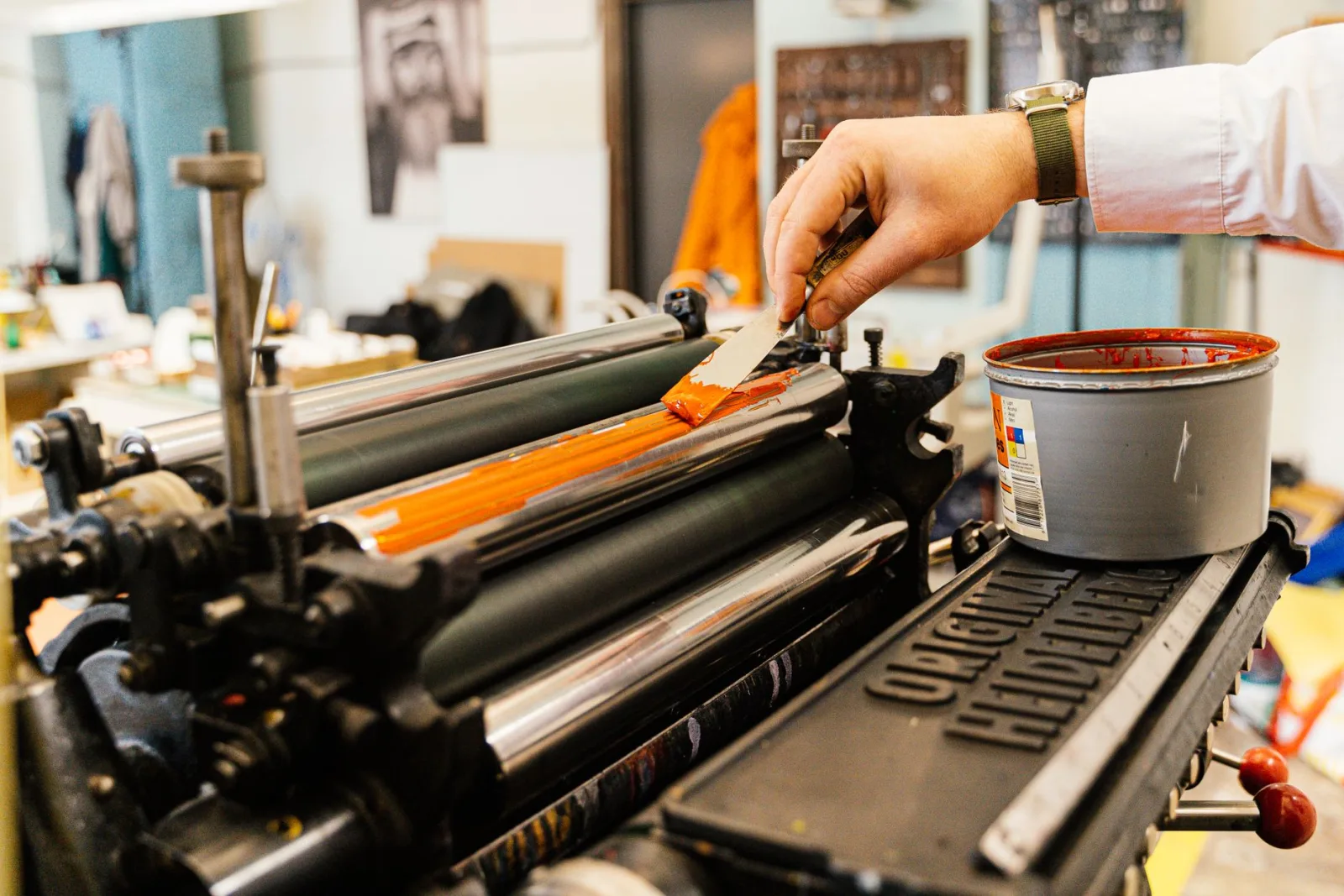Applying orange ink, the physical process CMYK conversion prepares for