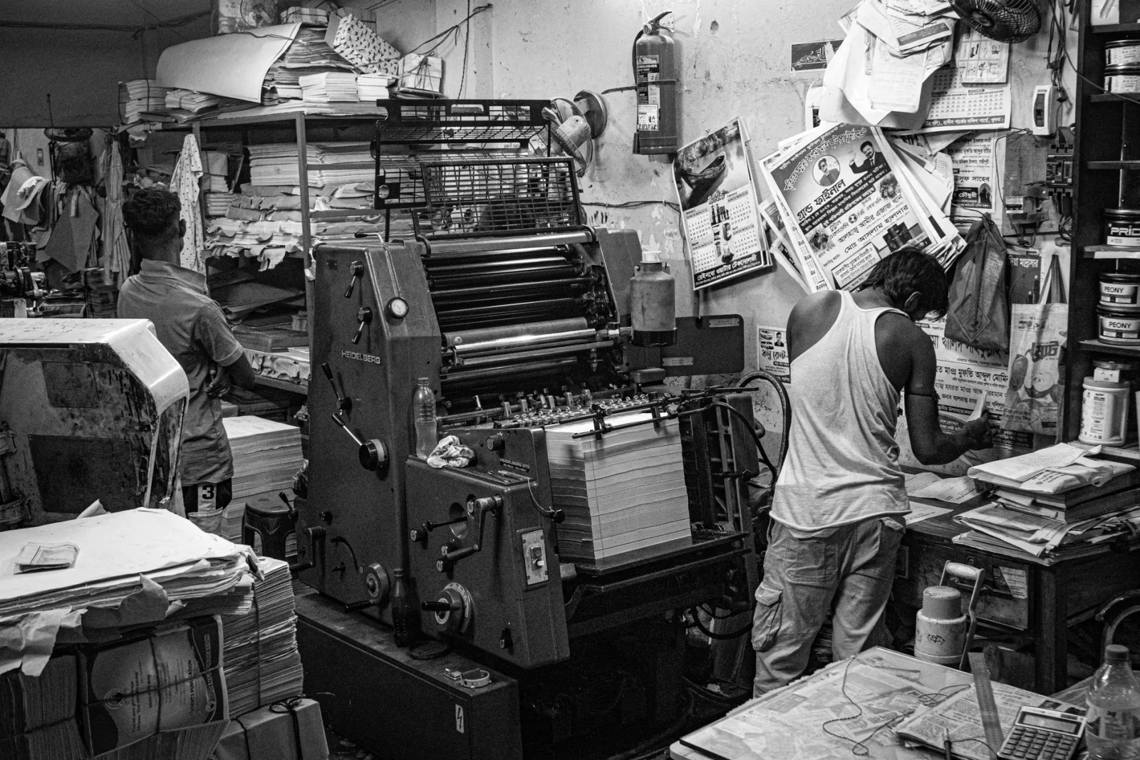A black-and-white print shop scene showing where DPI decisions translate to physical output