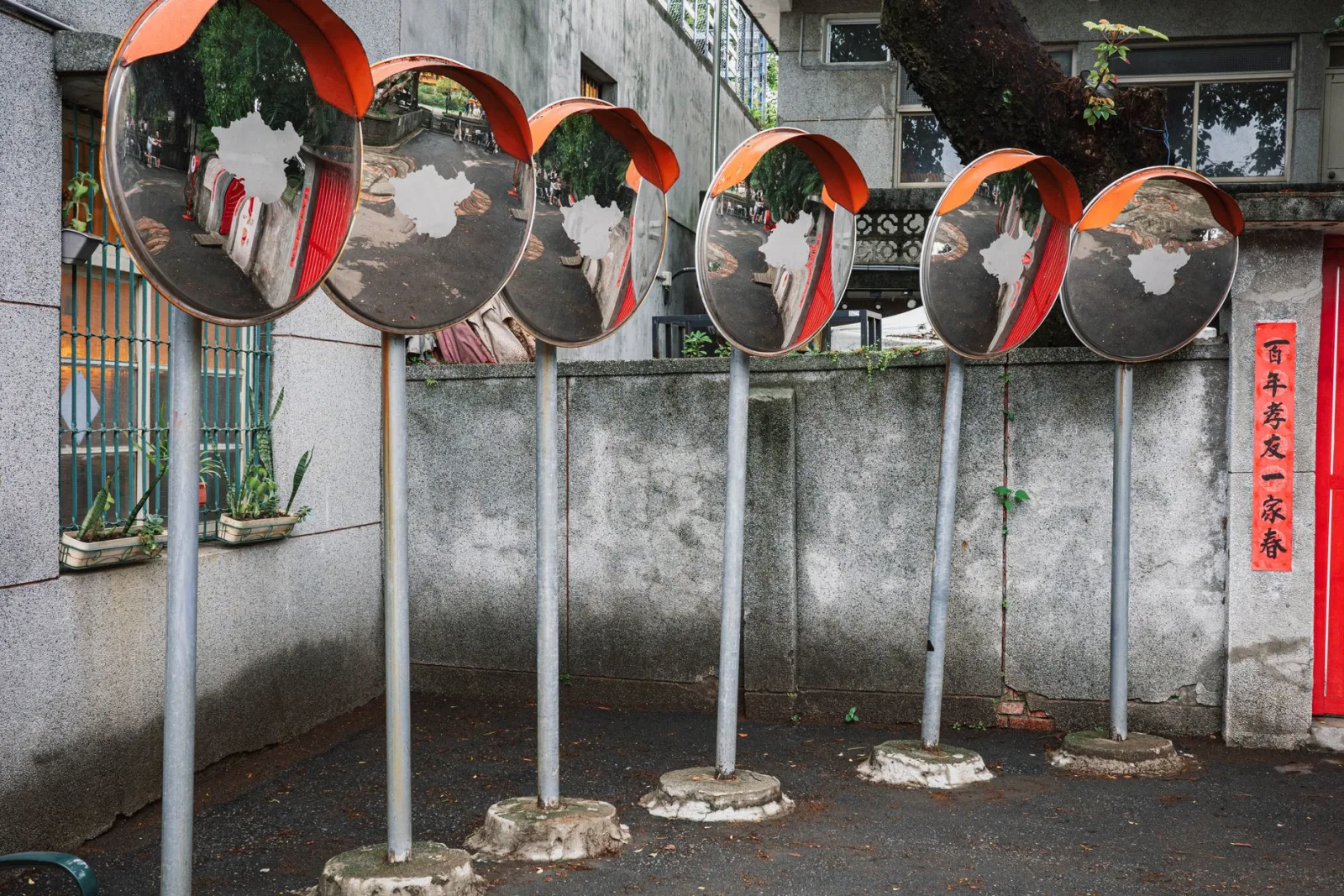 A row of convex street mirrors reflecting the scene, the principle behind reflection effects