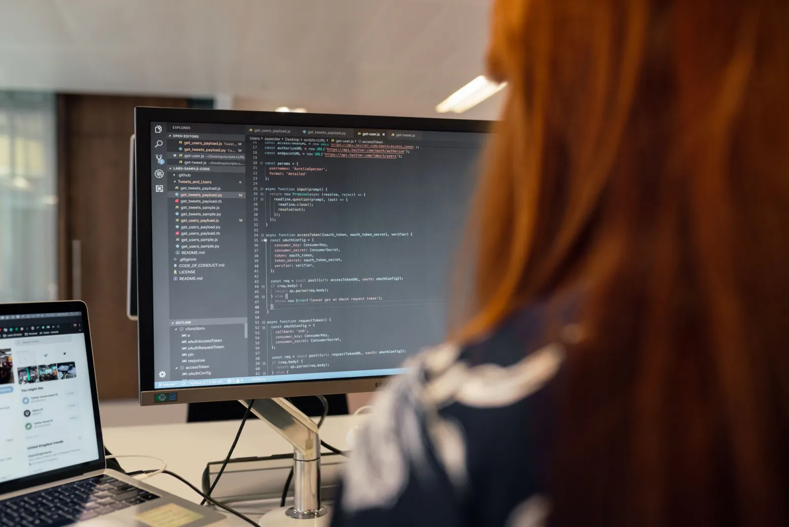 Software engineer coding image optimization and schema markup at a desk