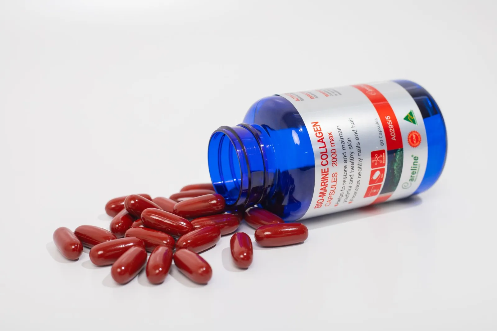 Product capsules spilling from a bottle, a complex product with transparency and small parts