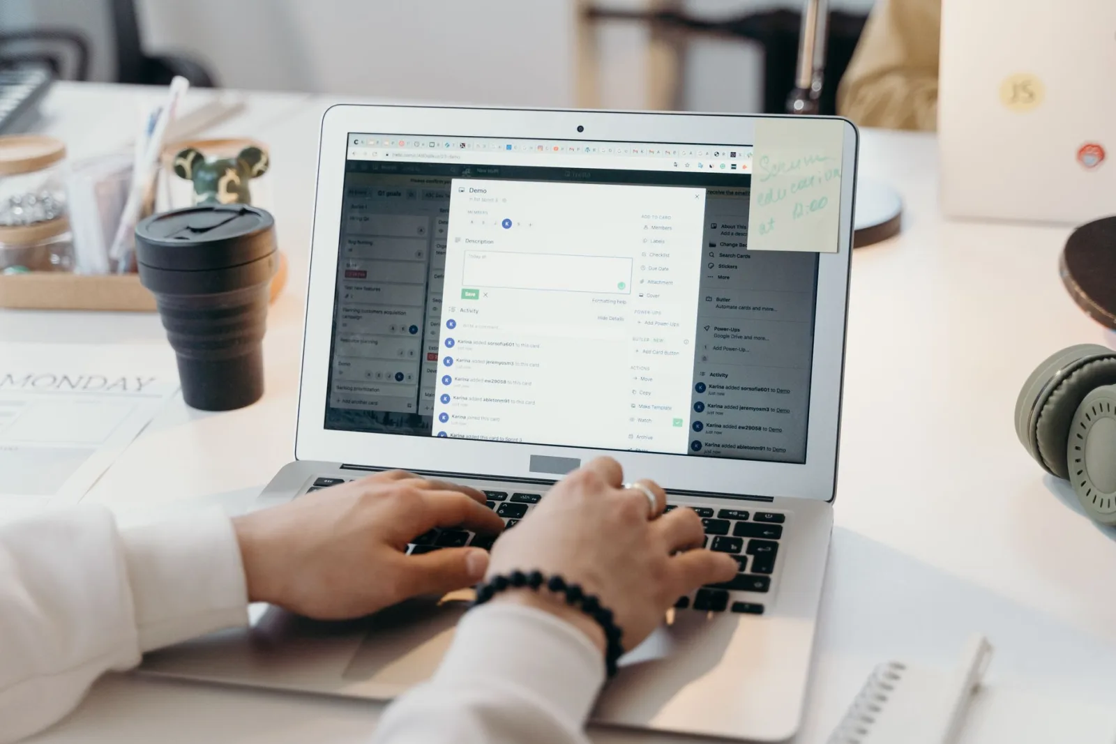 A person typing on a laptop in a bright office, preparing images for an email campaign