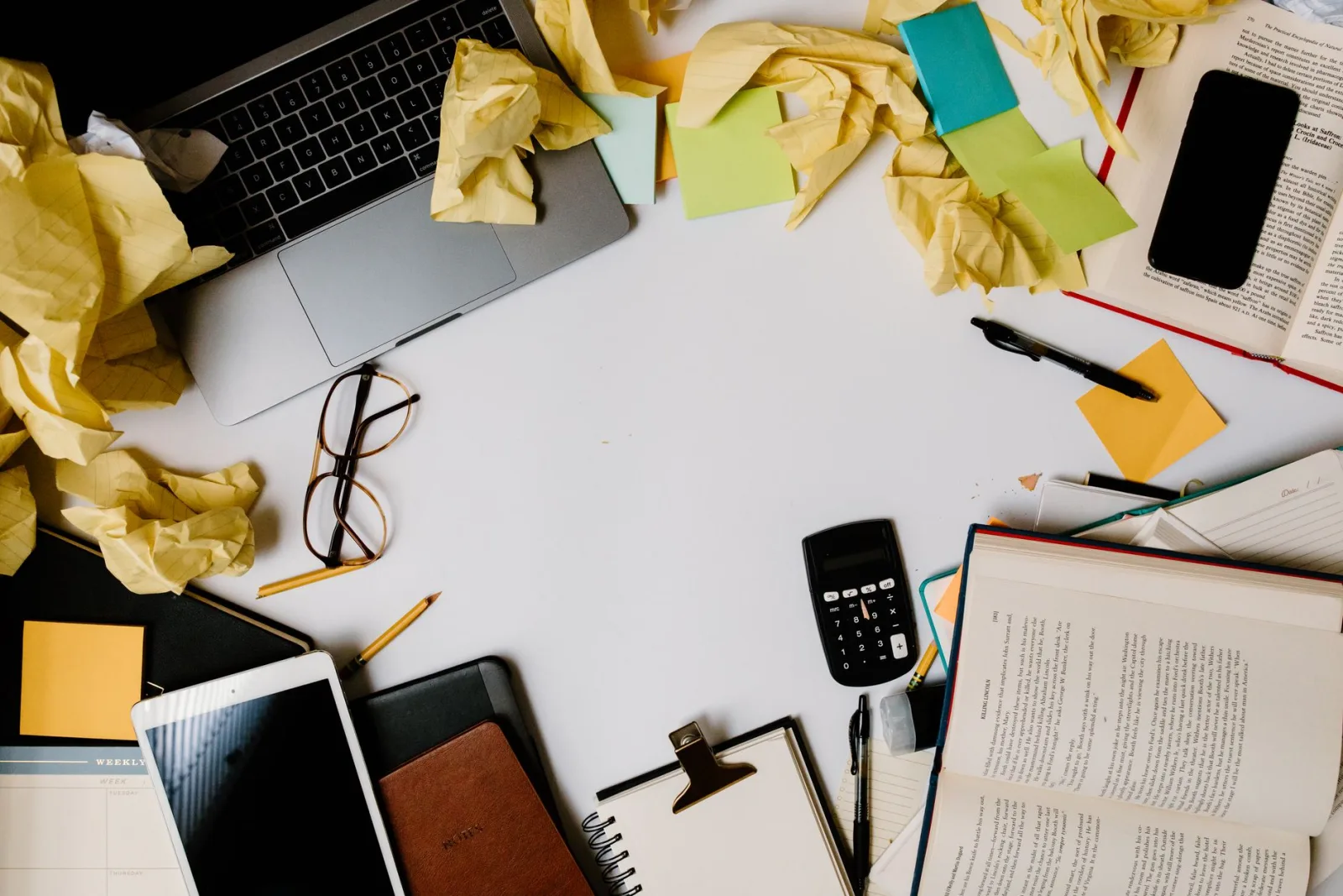 A cluttered office desk with objects that could be cleaned up with object removal