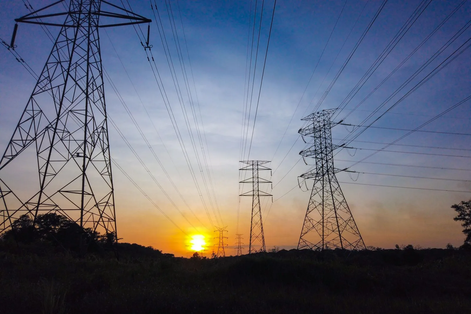 Power lines stretching across a sunset sky, a classic object-removal target that cleans up easily