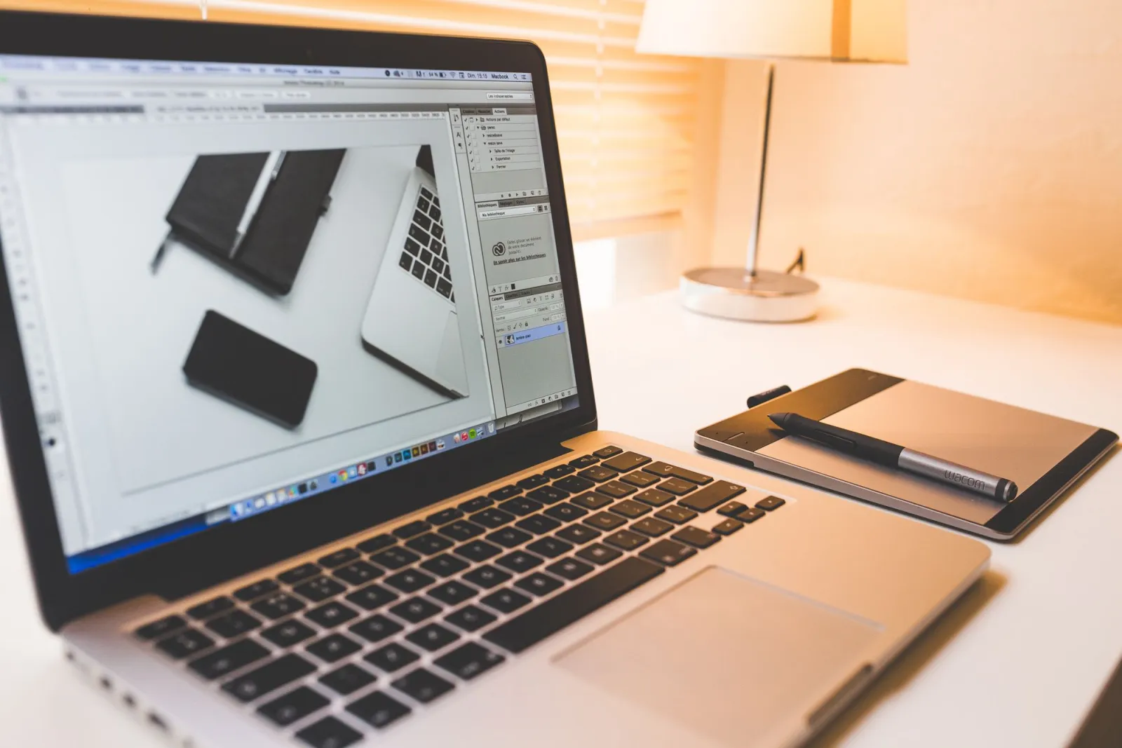 Modern workspace featuring a laptop, digital pen, and pad for creative work