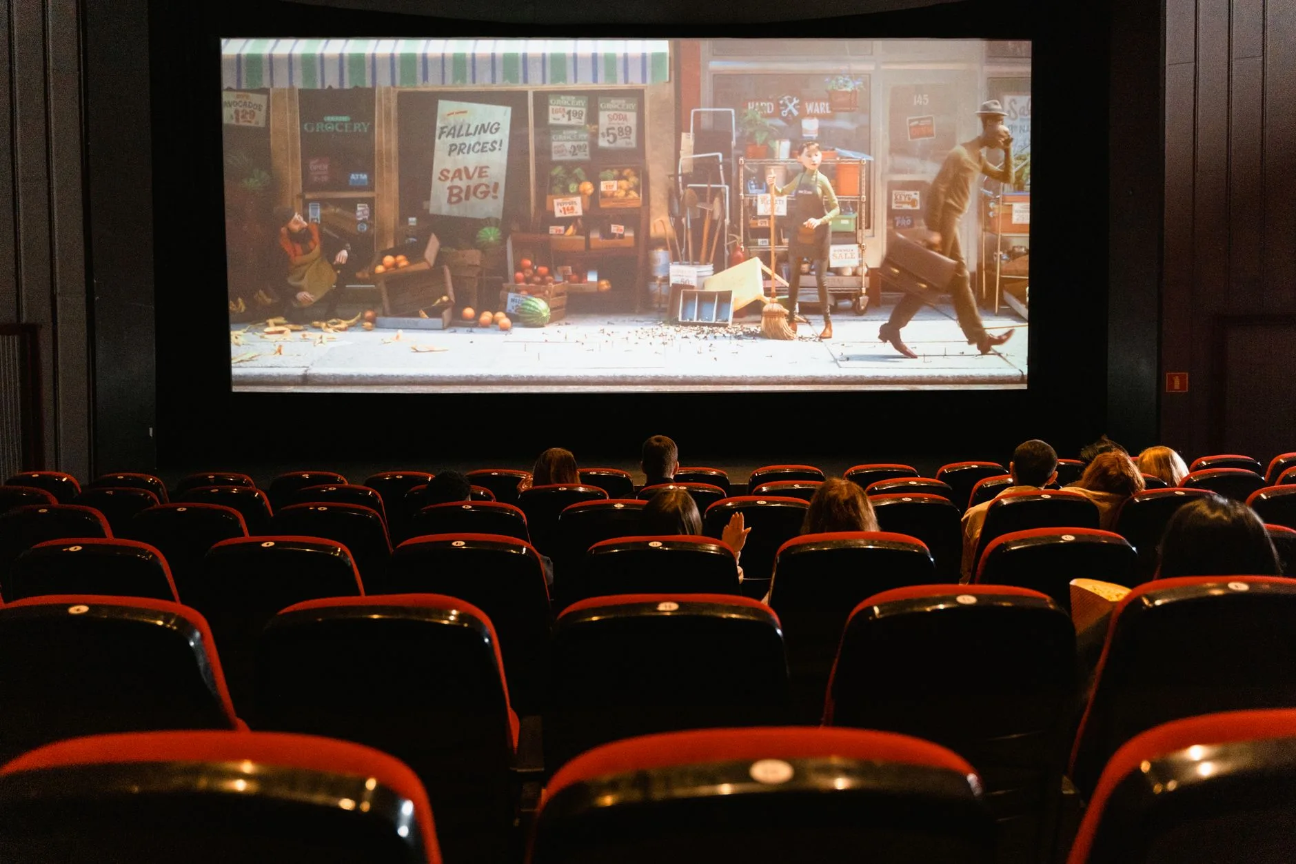 A cozy indoor movie theater showing an animated film to an audience