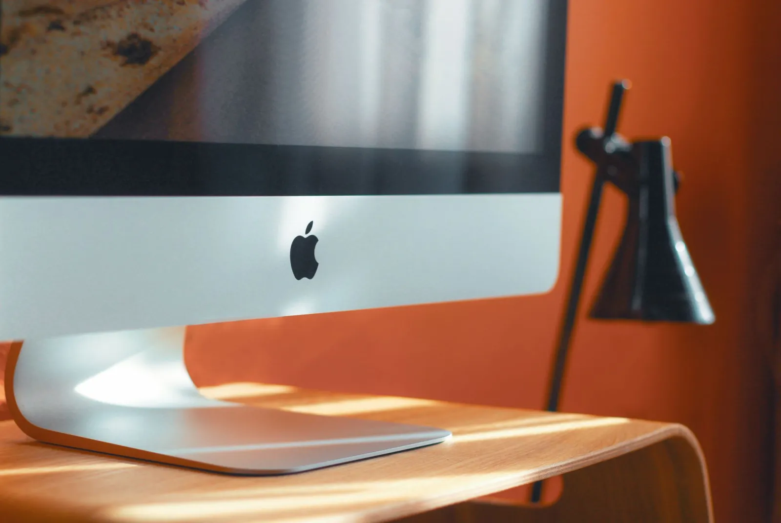 Sleek laptop on a wooden desk in a clean workspace for logo and icon design work