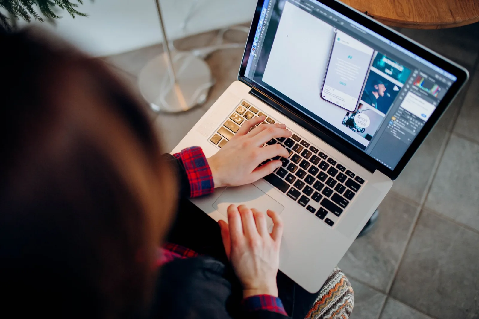 A designer working in creative software on a laptop, the prompt-authoring side of generation