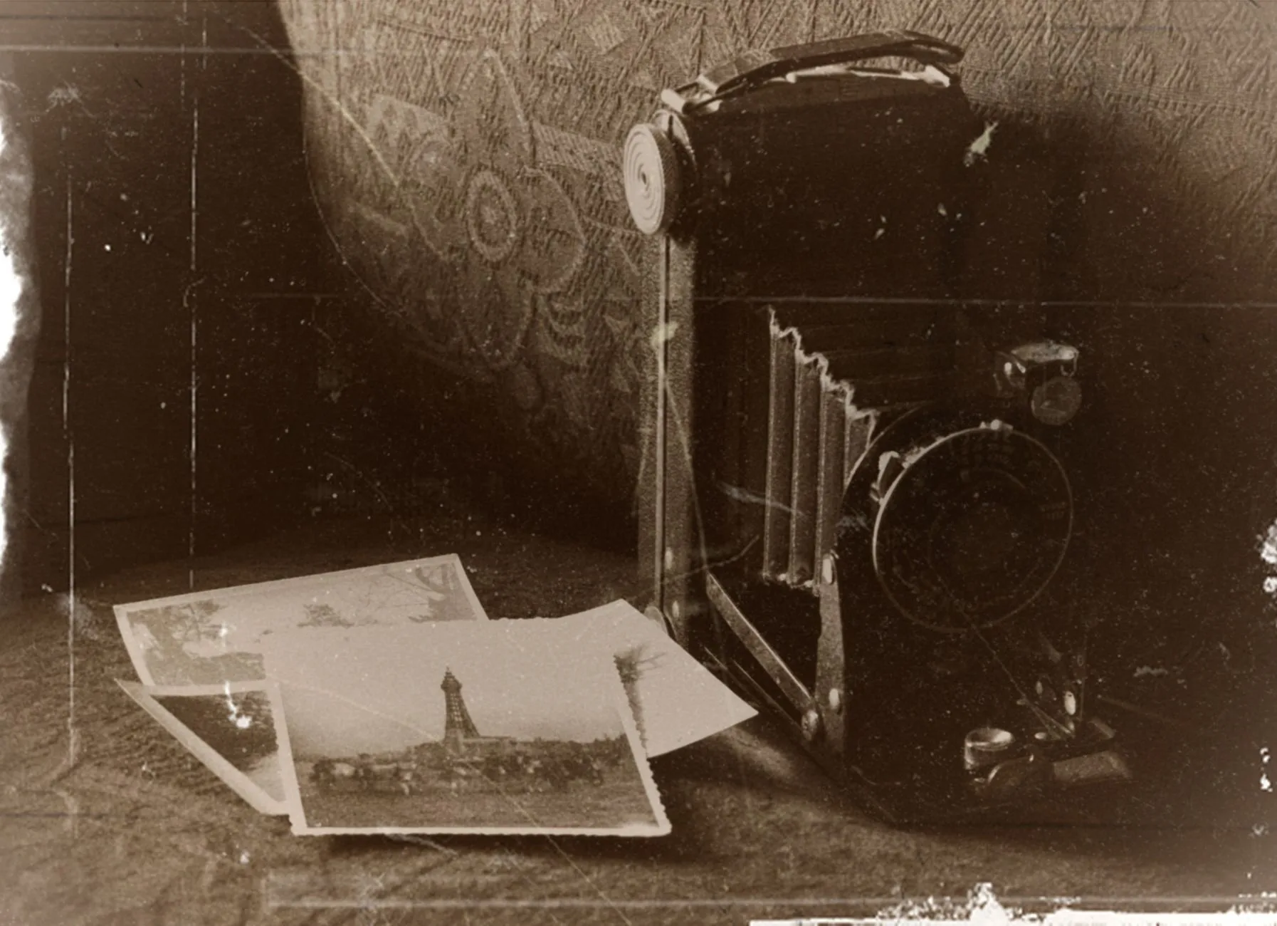 Sepia-toned vintage camera with old photographs, capturing nostalgic memories