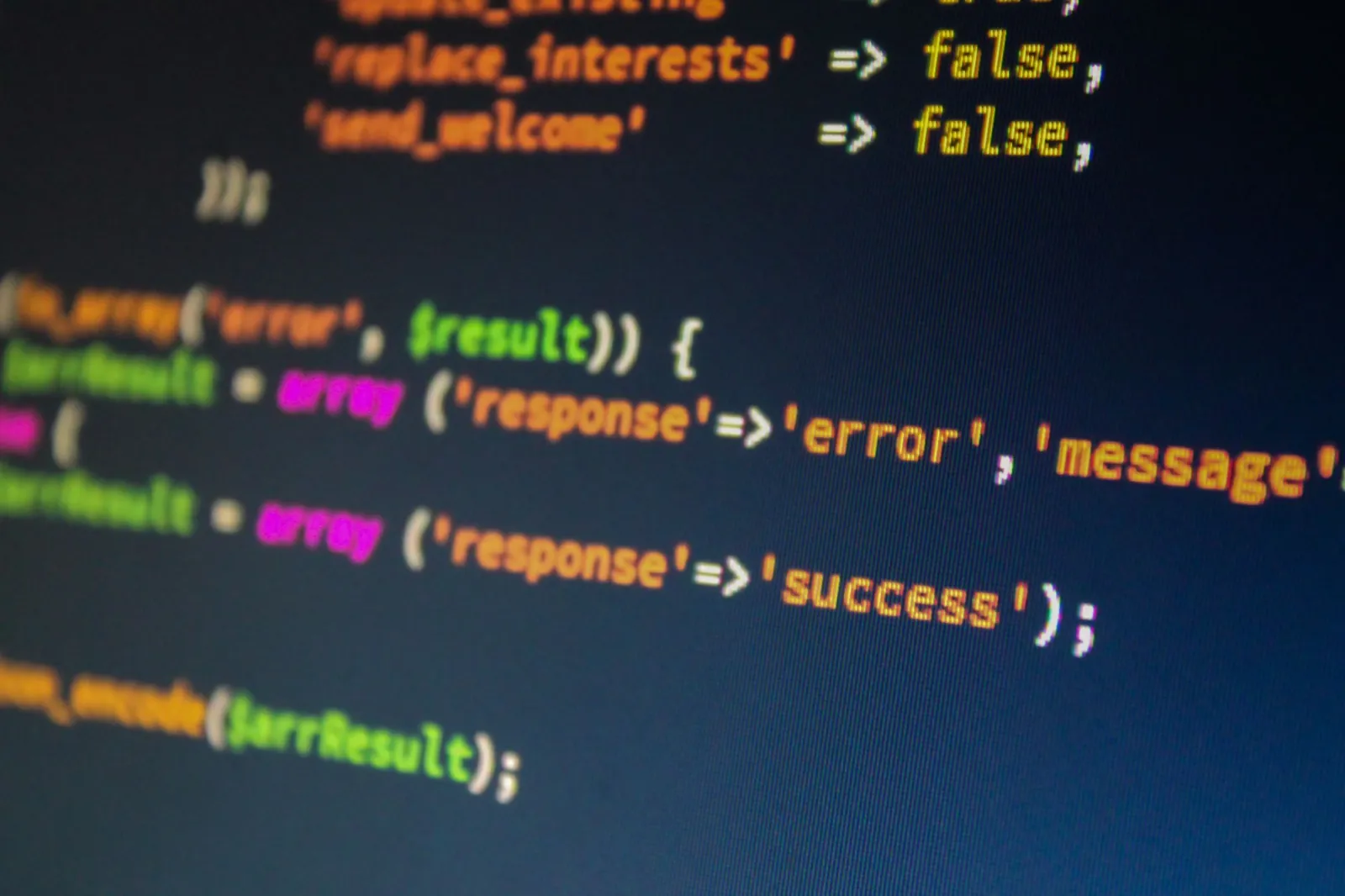 Dual screen developer setup showing code and image editing software